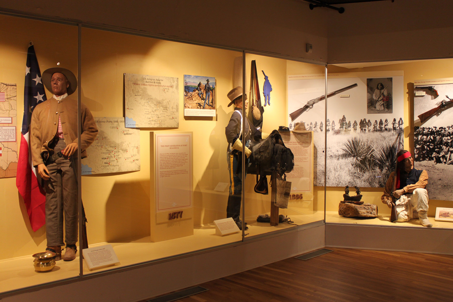 Corner museum display with several artifacts inside glass enclosure_C.